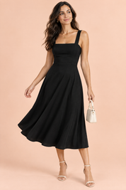 Robe midi noire à fines bretelles et jupe évasée | Vue de face | Lounelle Paris