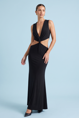 Robe longue noire à encolure asymétrique, découpes à la taille et détails dorés
