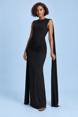 Robe longue noire moulante à col bateau, manches cape et dos ouvert